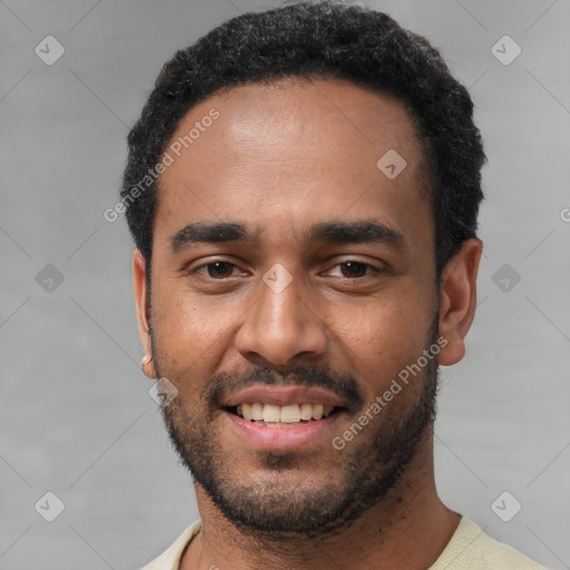 Joyful black young-adult male with short  black hair and brown eyes