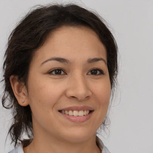 Joyful latino young-adult female with medium  brown hair and brown eyes