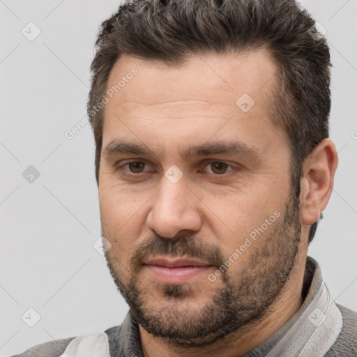 Joyful white adult male with short  brown hair and brown eyes