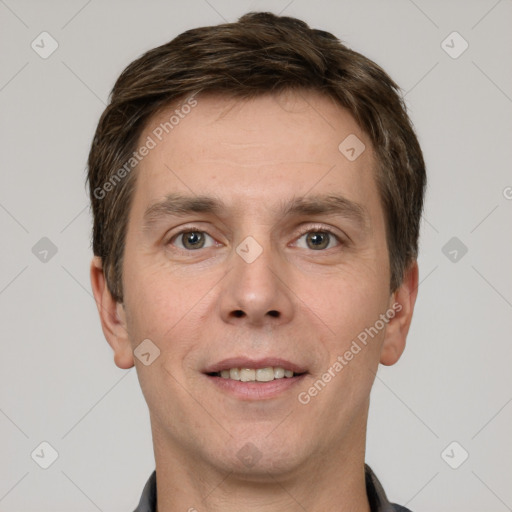 Joyful white adult male with short  brown hair and grey eyes