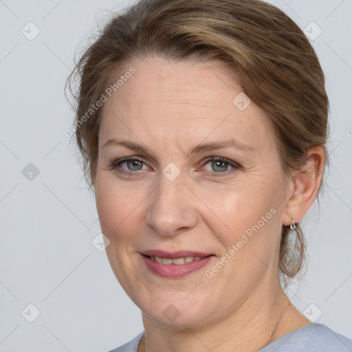 Joyful white adult female with medium  brown hair and grey eyes