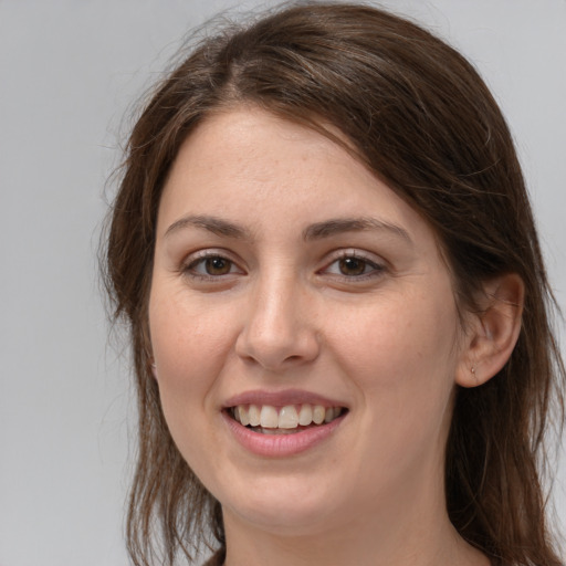 Joyful white young-adult female with long  brown hair and grey eyes