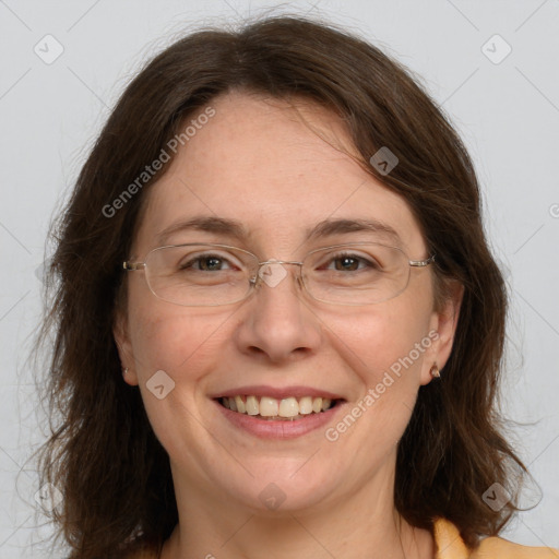 Joyful white adult female with medium  brown hair and grey eyes