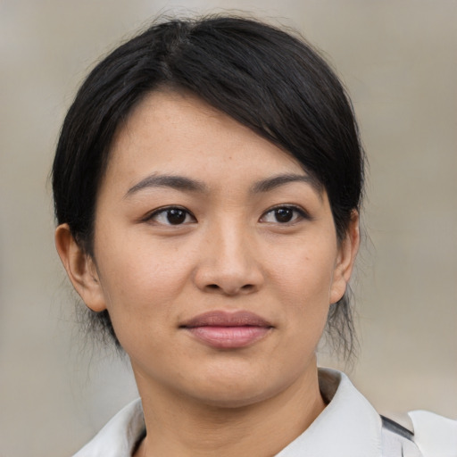 Joyful asian young-adult female with medium  black hair and brown eyes