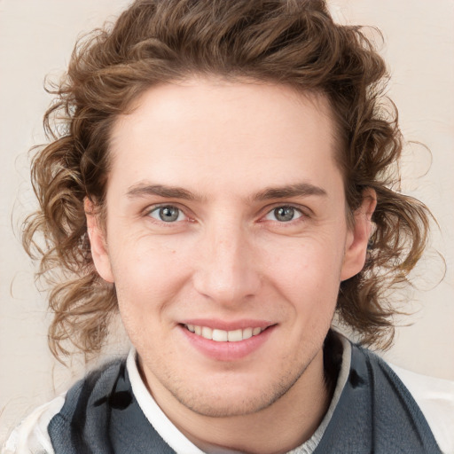 Joyful white young-adult male with medium  brown hair and blue eyes