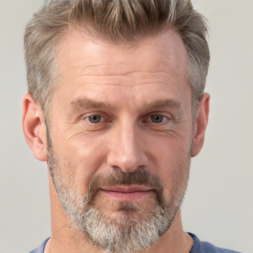 Joyful white middle-aged male with short  brown hair and brown eyes