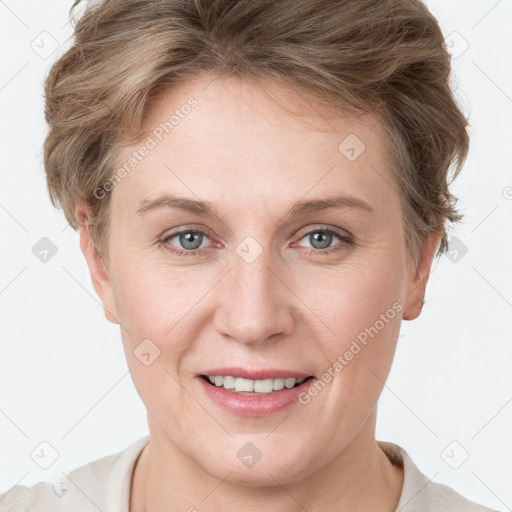 Joyful white young-adult female with short  brown hair and grey eyes