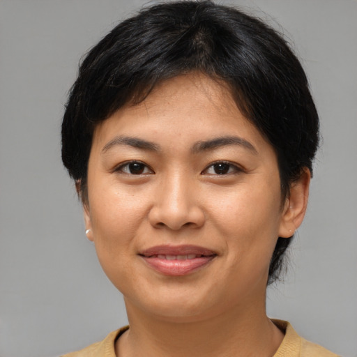Joyful asian young-adult female with short  brown hair and brown eyes