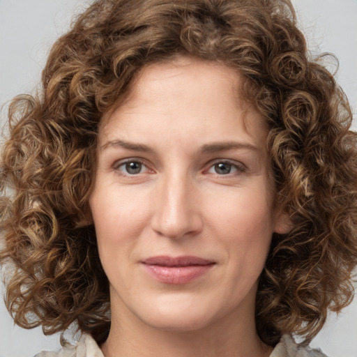 Joyful white young-adult female with medium  brown hair and green eyes