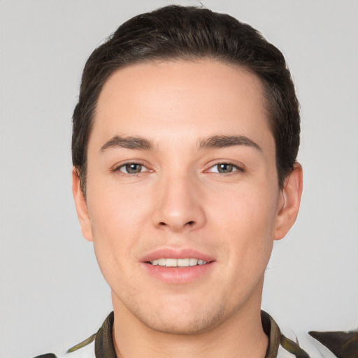 Joyful white young-adult male with short  brown hair and brown eyes