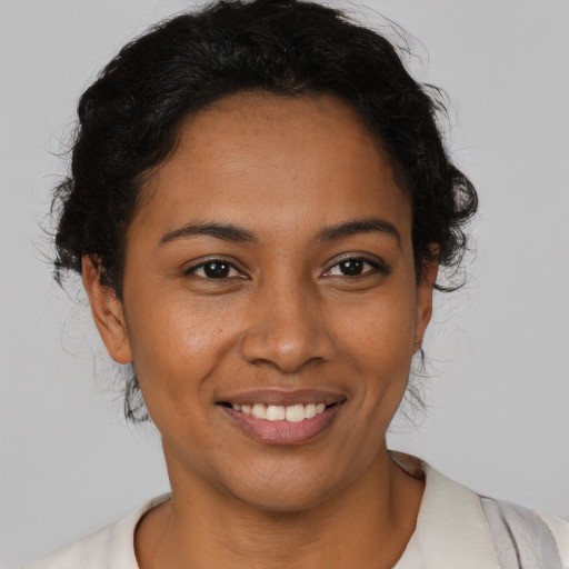 Joyful latino young-adult female with short  brown hair and brown eyes