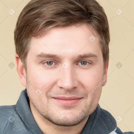 Joyful white young-adult male with short  brown hair and grey eyes