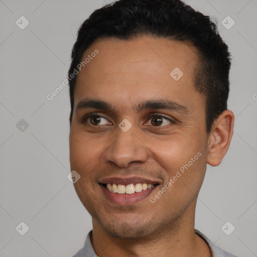 Joyful latino young-adult male with short  brown hair and brown eyes