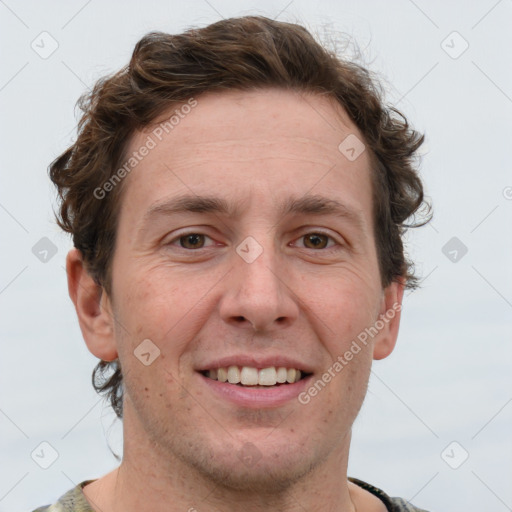 Joyful white adult male with short  brown hair and grey eyes