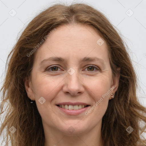 Joyful white adult female with long  brown hair and brown eyes