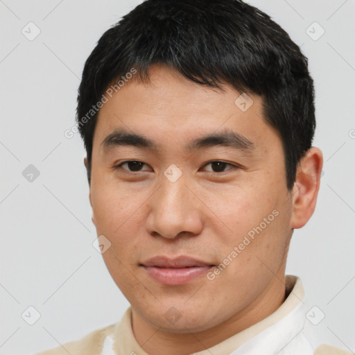 Joyful asian young-adult male with short  black hair and brown eyes