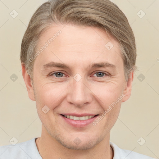 Joyful white adult male with short  brown hair and grey eyes