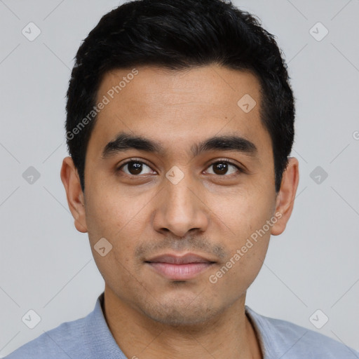 Joyful latino young-adult male with short  black hair and brown eyes