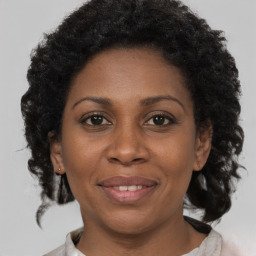 Joyful black adult female with short  brown hair and brown eyes