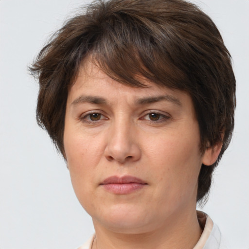 Joyful white adult female with short  brown hair and brown eyes