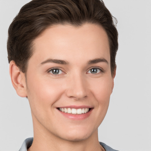 Joyful white young-adult female with short  brown hair and grey eyes