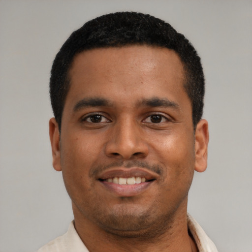 Joyful latino young-adult male with short  black hair and brown eyes