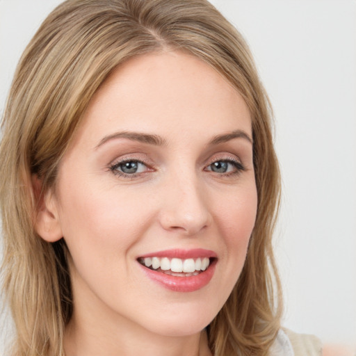 Joyful white young-adult female with long  brown hair and green eyes