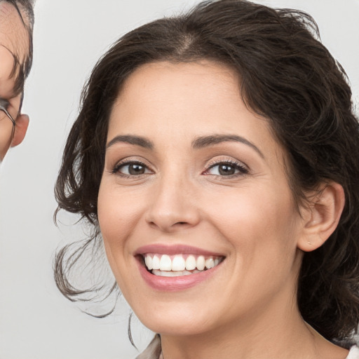 Joyful white young-adult female with medium  brown hair and brown eyes