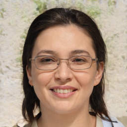 Joyful white adult female with medium  brown hair and brown eyes