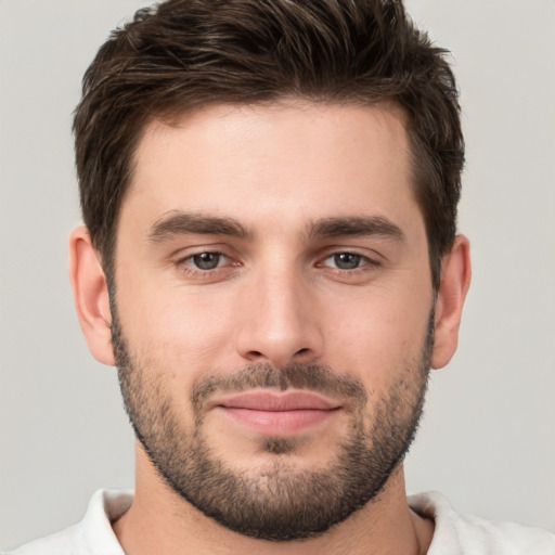 Joyful white young-adult male with short  brown hair and brown eyes