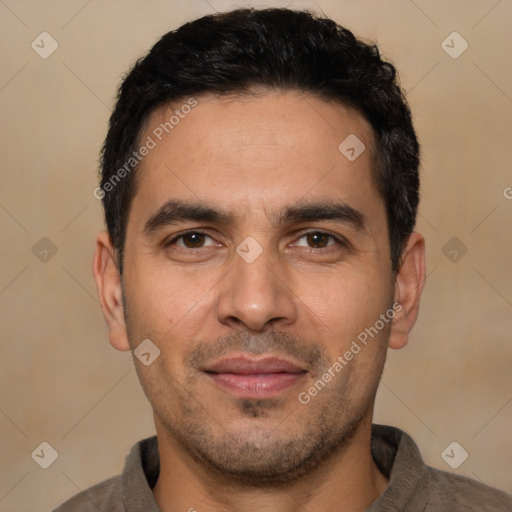 Joyful white young-adult male with short  black hair and brown eyes