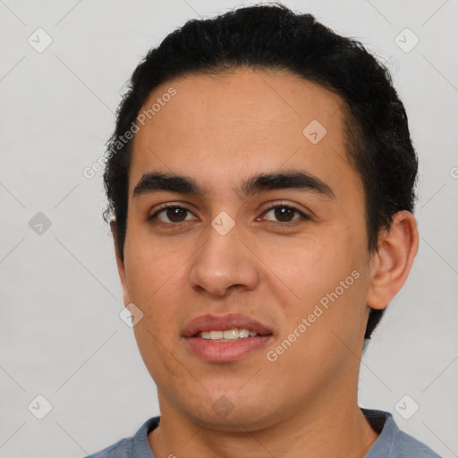 Joyful latino young-adult male with short  black hair and brown eyes