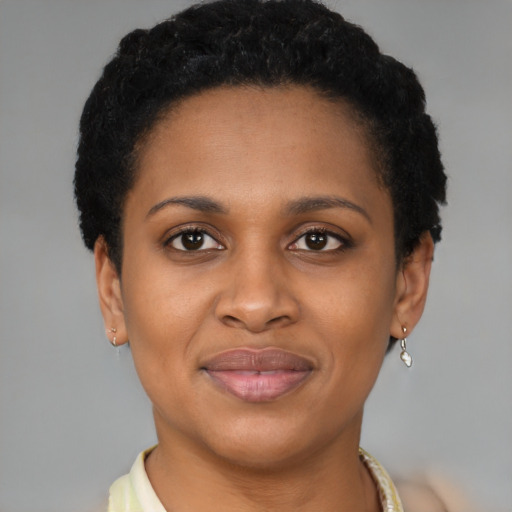 Joyful black young-adult female with short  brown hair and brown eyes