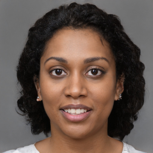 Joyful black young-adult female with medium  black hair and brown eyes