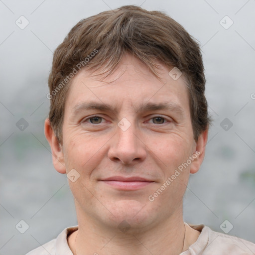 Joyful white adult male with short  brown hair and grey eyes