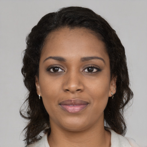 Joyful black young-adult female with medium  black hair and brown eyes