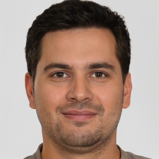 Joyful white young-adult male with short  brown hair and brown eyes