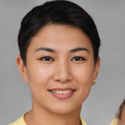 Joyful asian young-adult female with short  brown hair and brown eyes