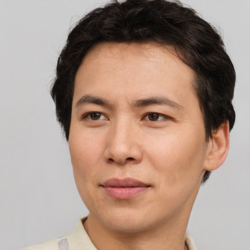 Joyful asian adult male with short  brown hair and brown eyes