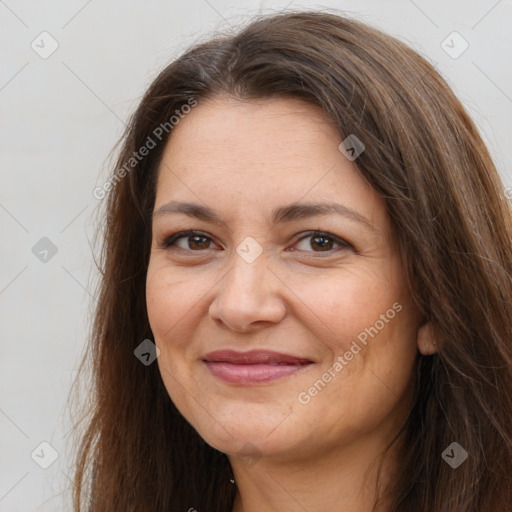 Joyful white adult female with long  brown hair and brown eyes