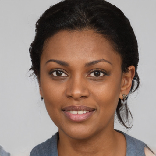 Joyful black young-adult female with medium  brown hair and brown eyes