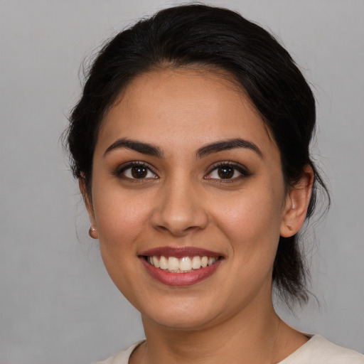 Joyful white young-adult female with medium  brown hair and brown eyes