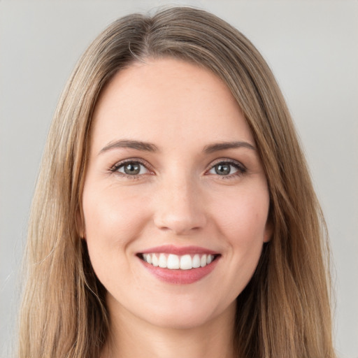 Joyful white young-adult female with long  brown hair and grey eyes