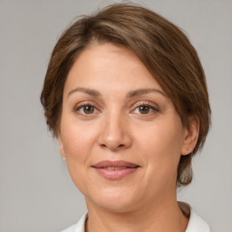 Joyful white adult female with medium  brown hair and brown eyes