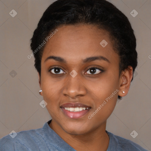 Joyful black young-adult female with short  black hair and brown eyes