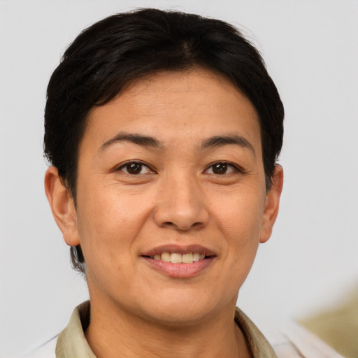 Joyful asian adult female with short  brown hair and brown eyes