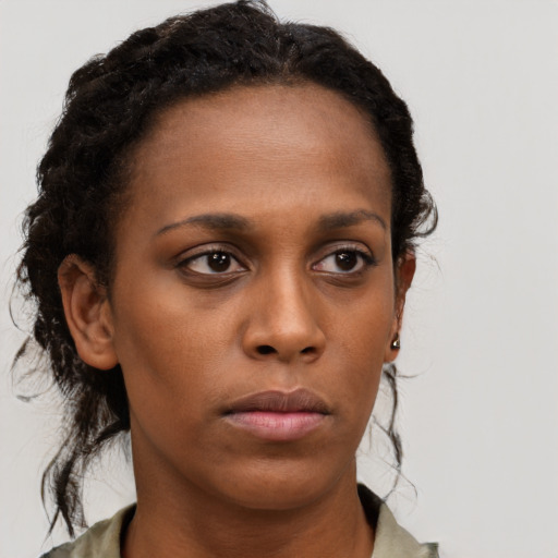 Neutral black young-adult female with long  brown hair and brown eyes
