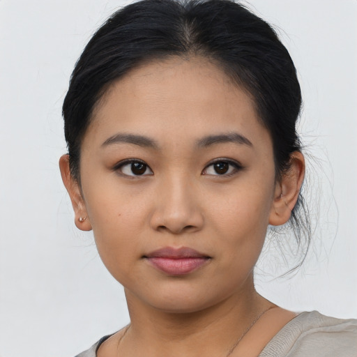 Joyful asian young-adult female with short  black hair and brown eyes