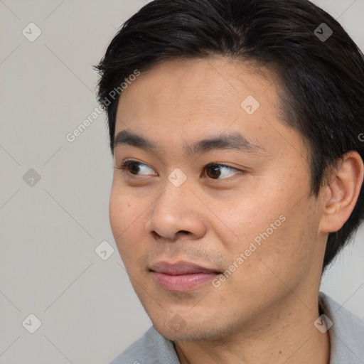 Joyful white young-adult male with short  black hair and brown eyes