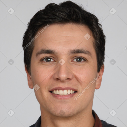 Joyful white young-adult male with short  black hair and brown eyes